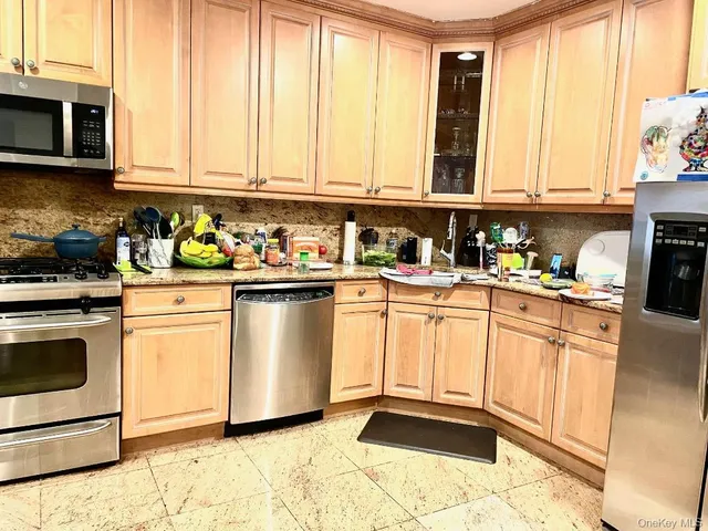 a kitchen with appliances cabinets and a sink
