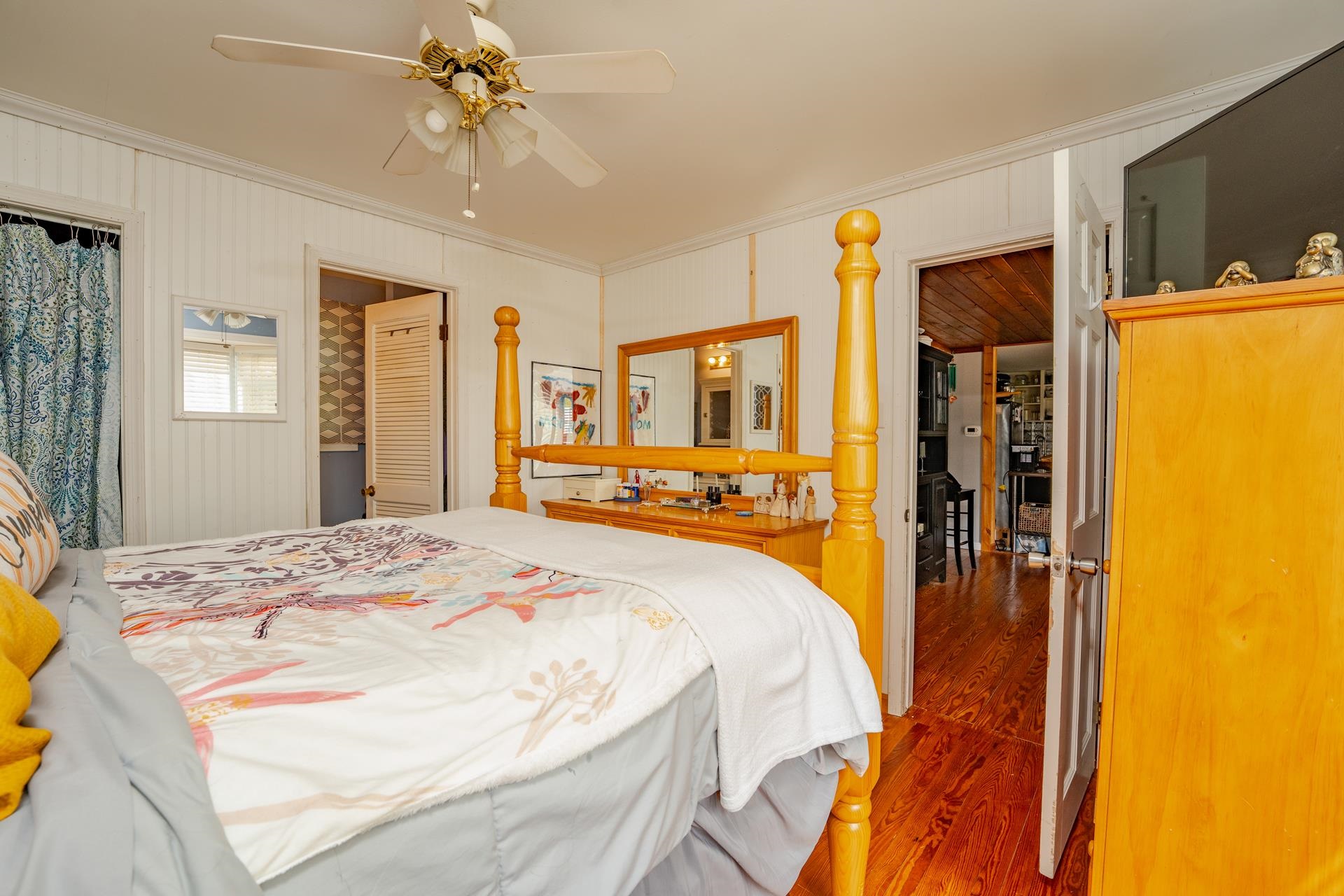 32 Norwood Road Marmora, NJ 08223 - Photo 15 of 32 a spacious bedroom with a bed and a chandelier