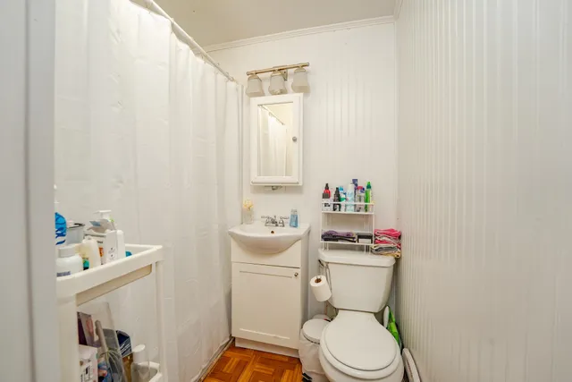 a white toilet sitting next to a bathroom sink
