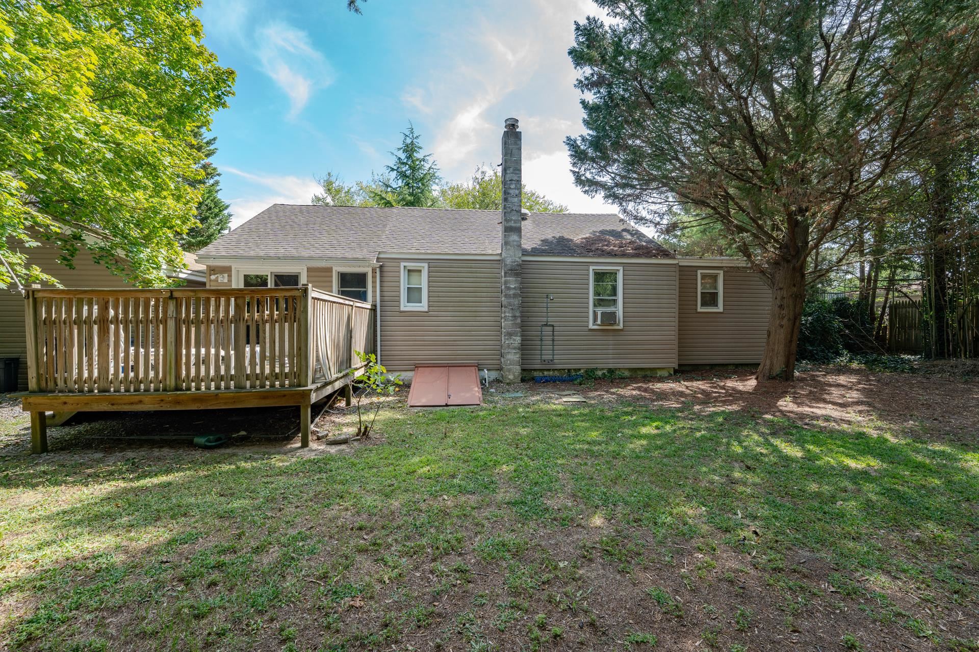32 Norwood Road Marmora, NJ 08223 - Photo 23 of 32 a view of a house with a yard and deck