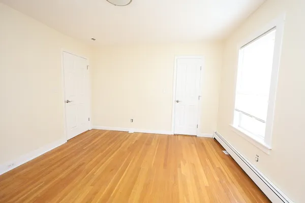 a view of a room with wooden floor and brick walls