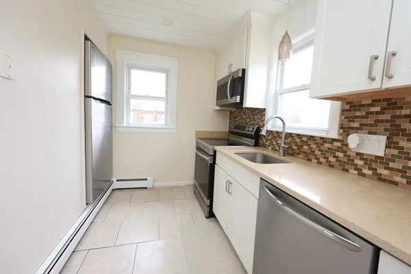 a kitchen with a sink cabinets and a window