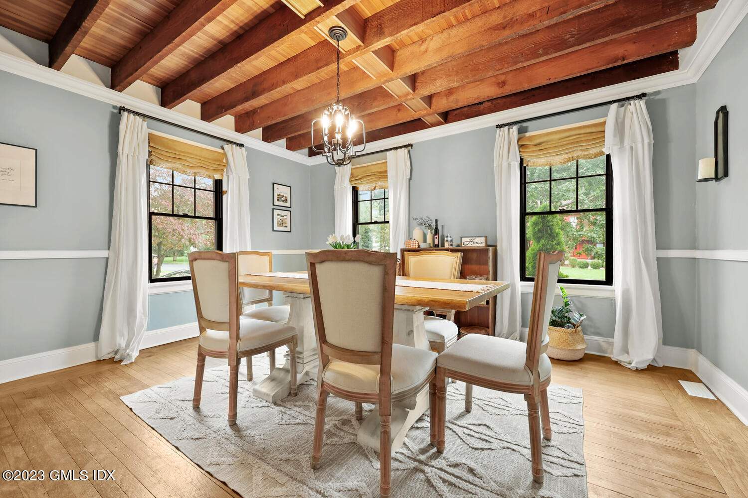 36 Ralph Street Stamford, CT 06902 - Photo 4 of 20 a dining room with furniture a chandelier and wooden floor