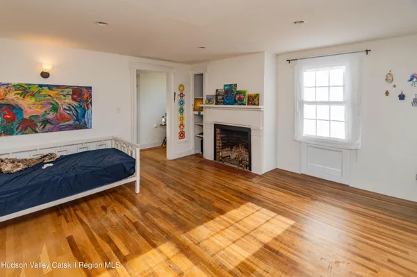 a living room with a rug and a fireplace