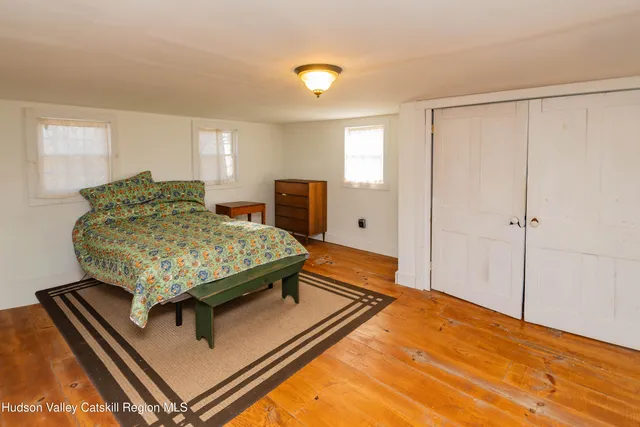 a living room with a bed furniture and a window