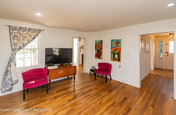 a living room with furniture a flat screen tv and a couch