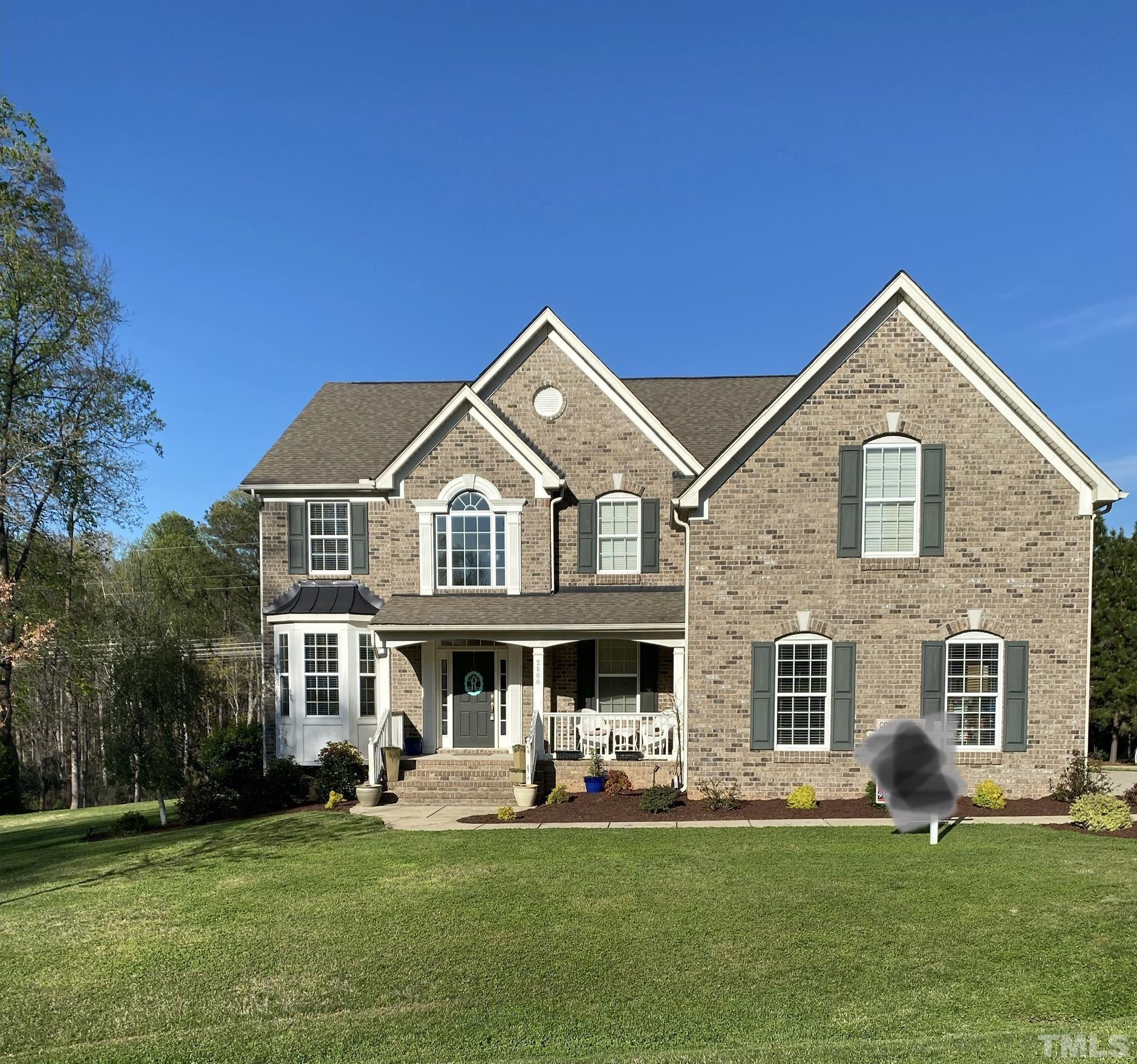2800 Bending Tree Court Raleigh, NC 27613 - Photo 1 of 49 a front view of a house with a garden