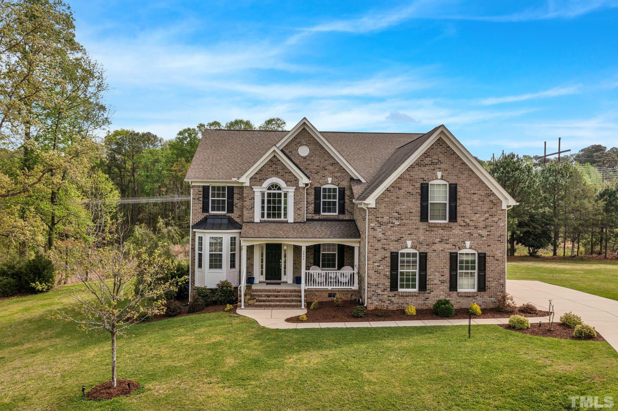 2800 Bending Tree Court Raleigh, NC 27613 - Photo 49 of 49 a front view of a house with a yard table and chairs