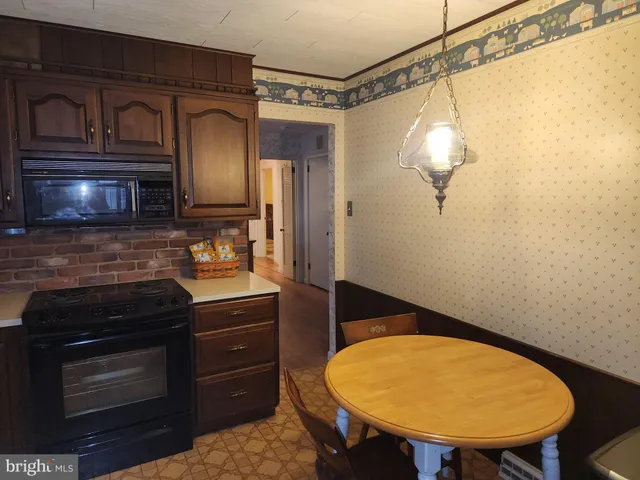 a bathroom with a sink a toilet a mirror and shower