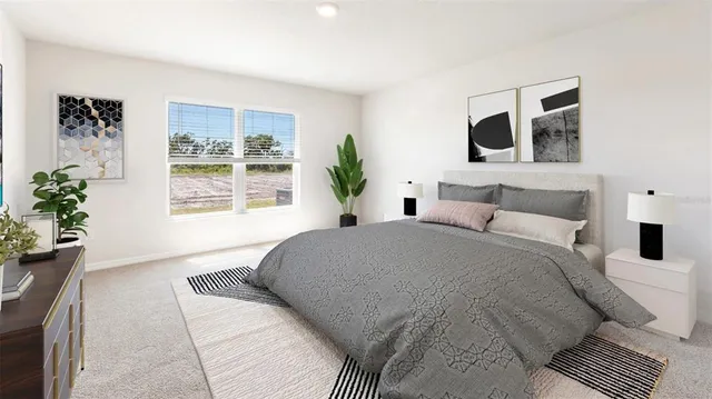 a bedroom with a large bed and a potted plant