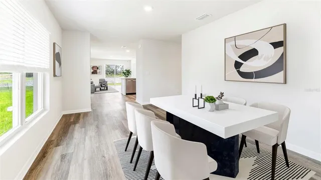 a view of a dining room with furniture window and wooden floor