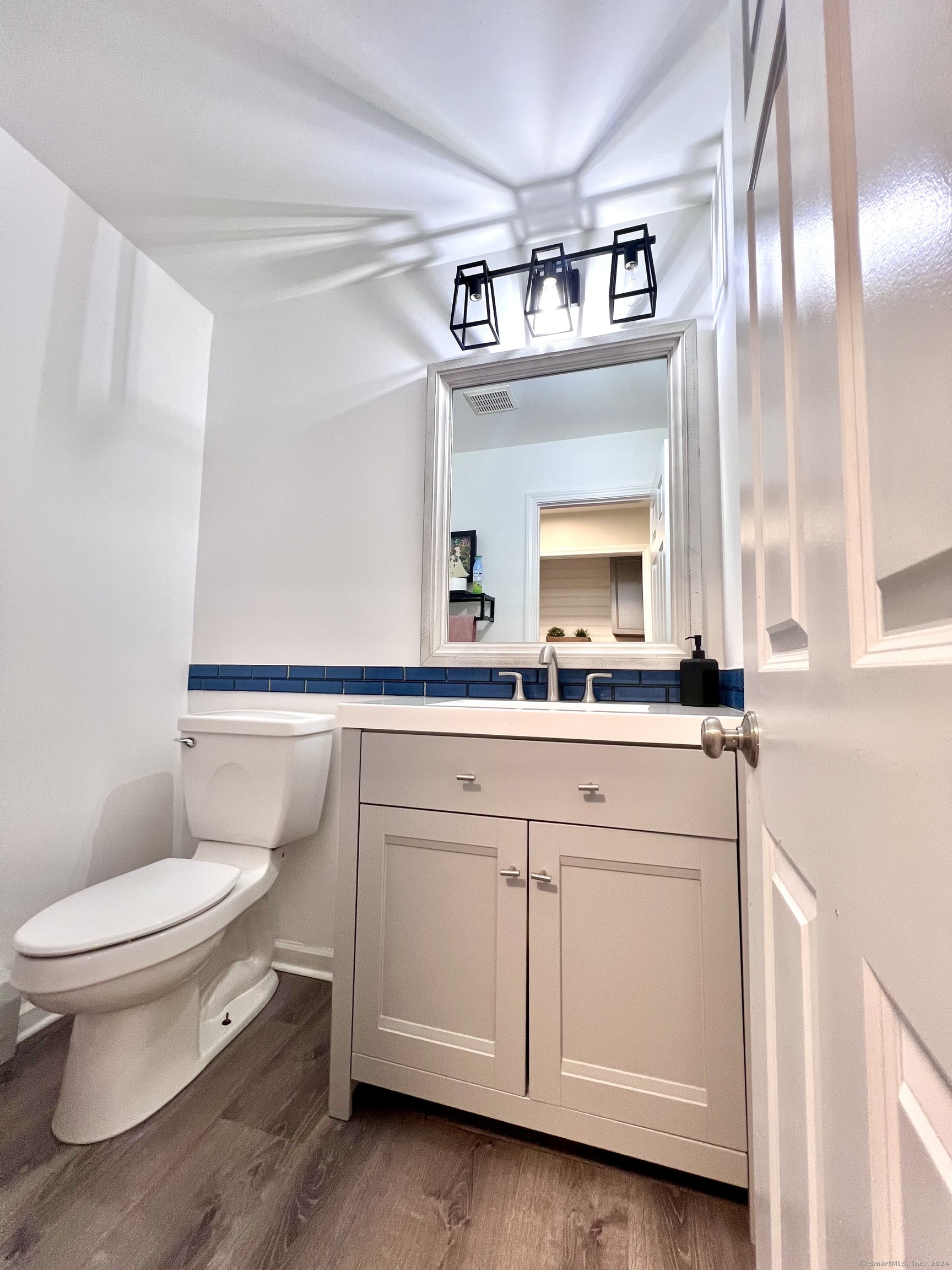 4 Cobblestone Court Naugatuck, CT 06770 - Photo 14 of 34 a bathroom with a sink a large mirror and a toilet
