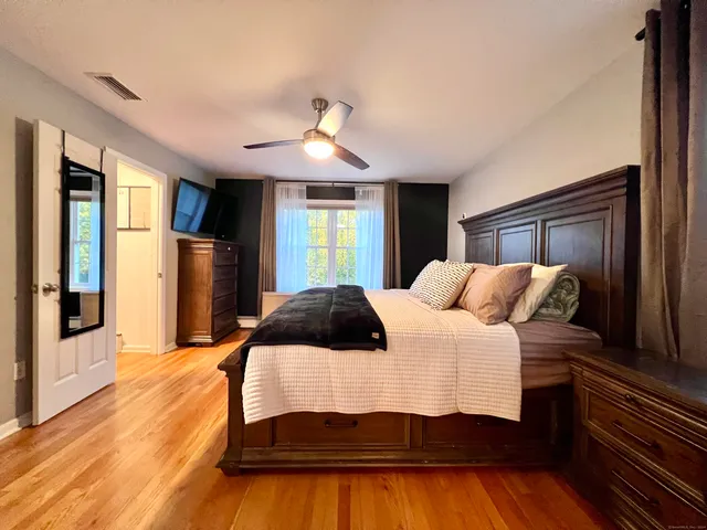 a bedroom with a large bed and a chandelier