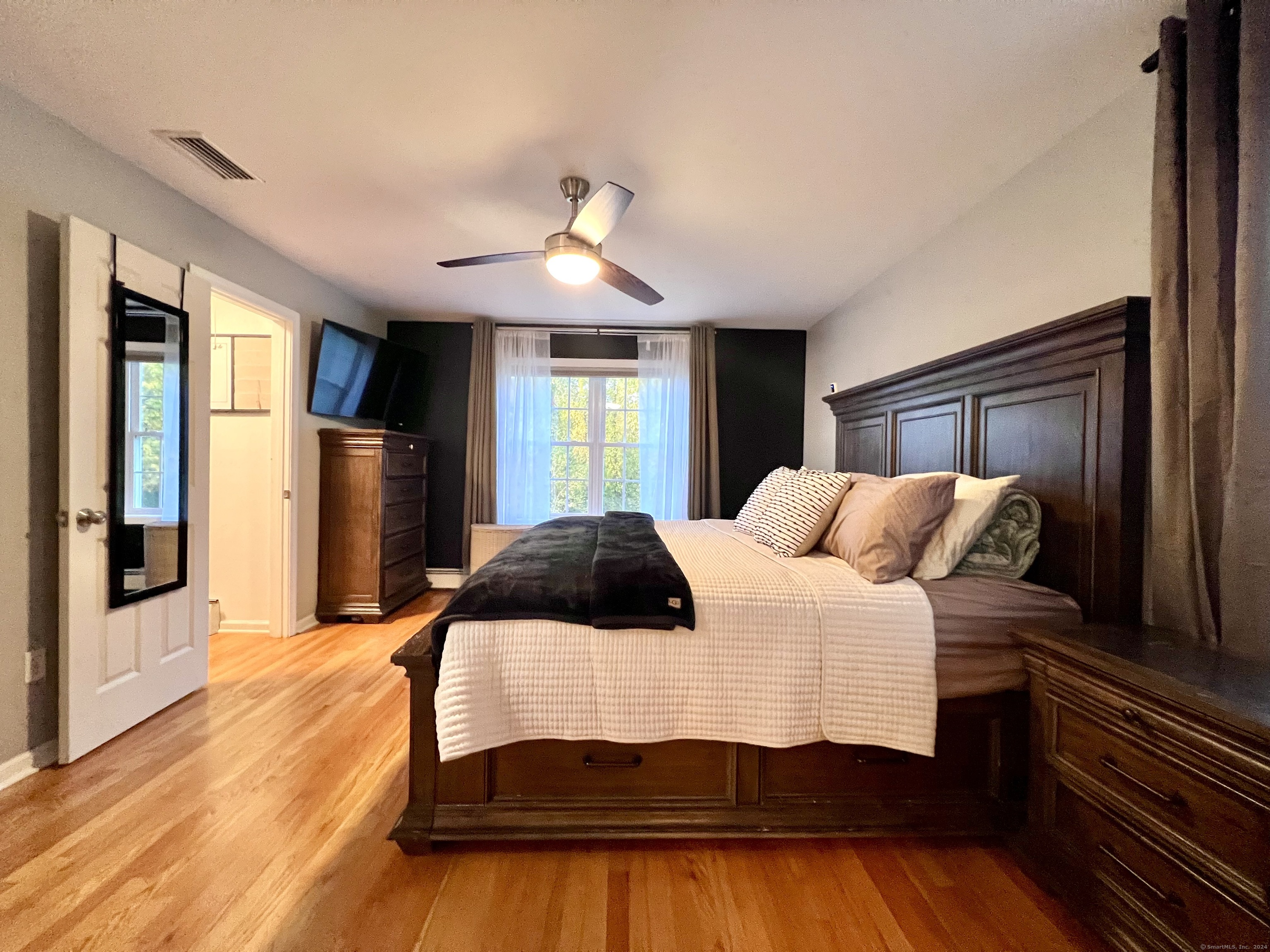 4 Cobblestone Court Naugatuck, CT 06770 - Photo 18 of 34 a bedroom with a large bed and a chandelier