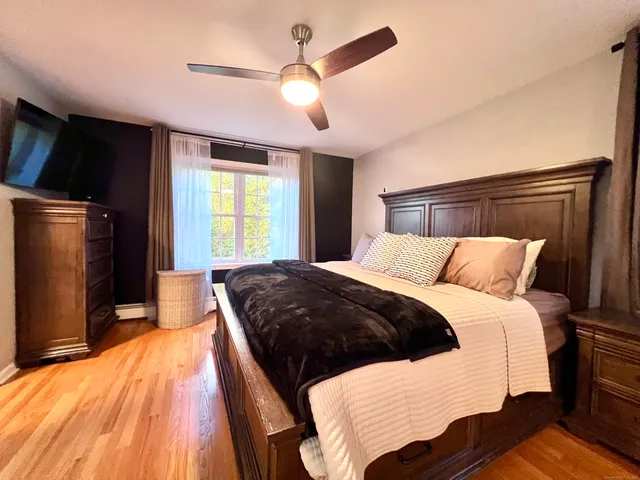 a bedroom with a large bed and a chandelier