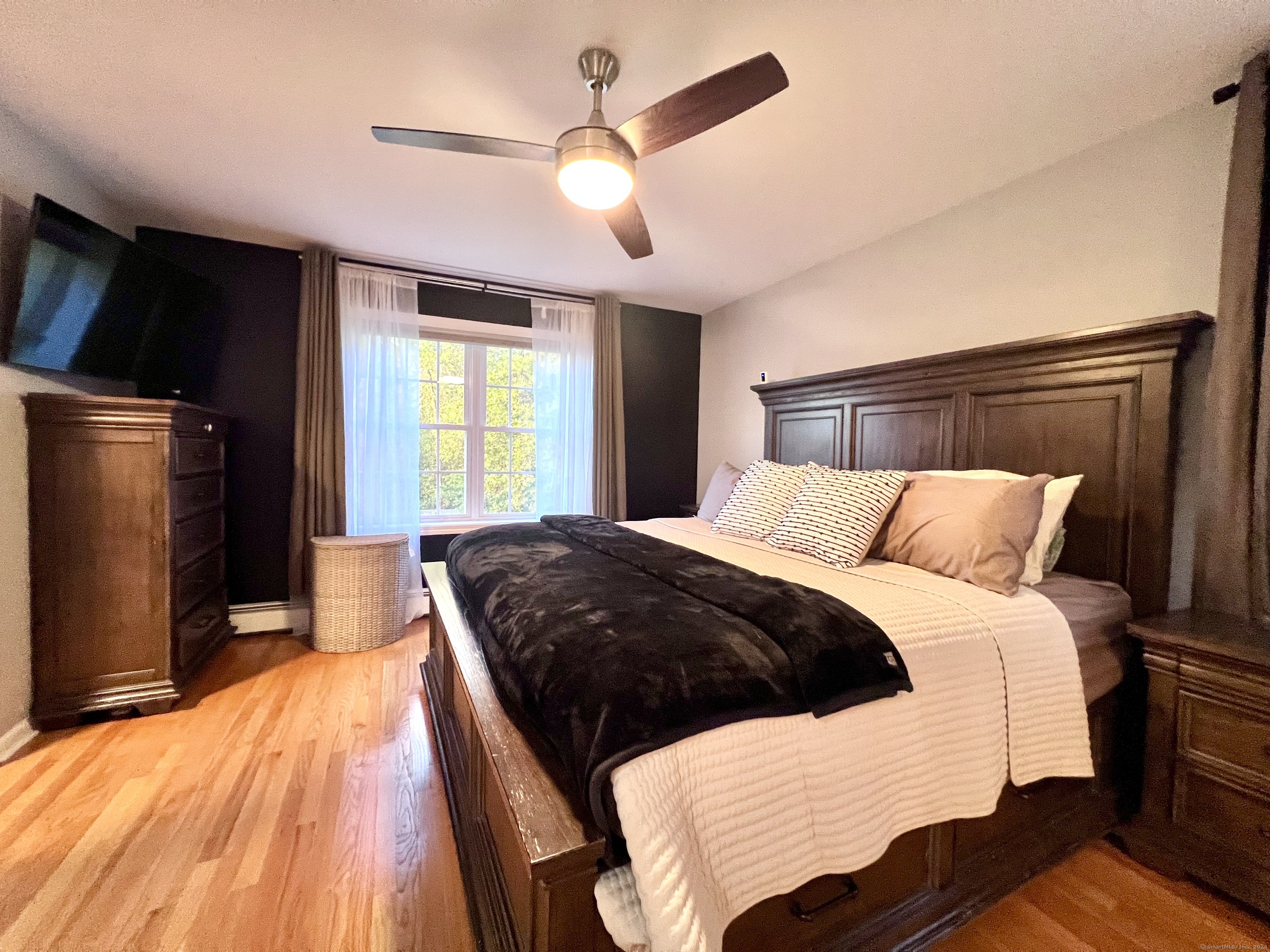 4 Cobblestone Court Naugatuck, CT 06770 - Photo 19 of 34 a bedroom with a large bed and a chandelier