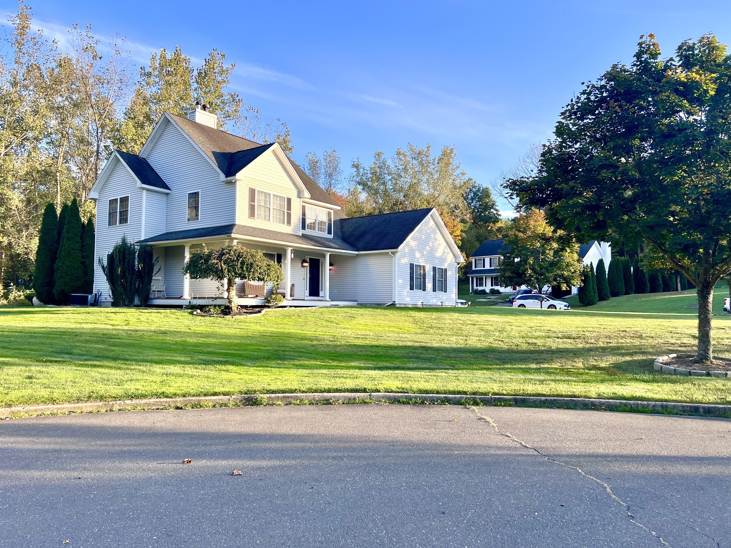 4 Cobblestone Court Naugatuck, CT 06770 - Photo 2 of 34 a front view of a house with a yard table and chairs