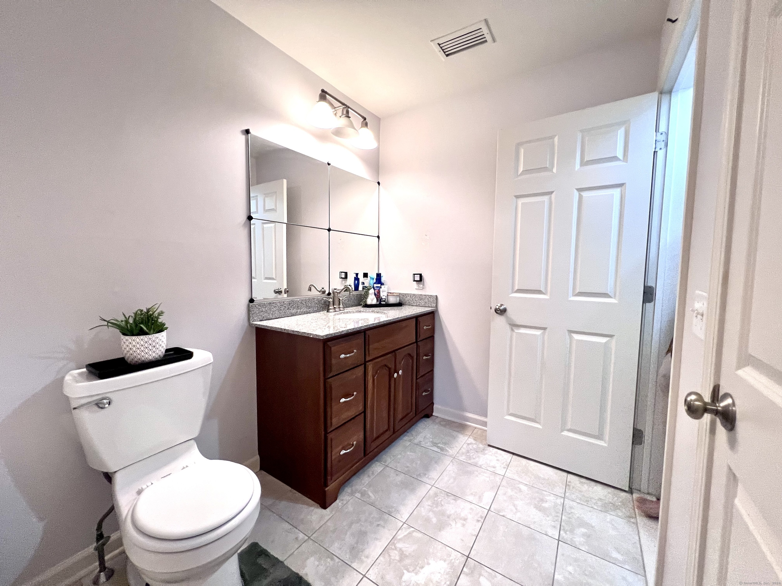 4 Cobblestone Court Naugatuck, CT 06770 - Photo 30 of 34 a bathroom with a toilet a sink and a mirror