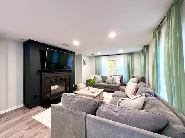 a living room with furniture and a fireplace