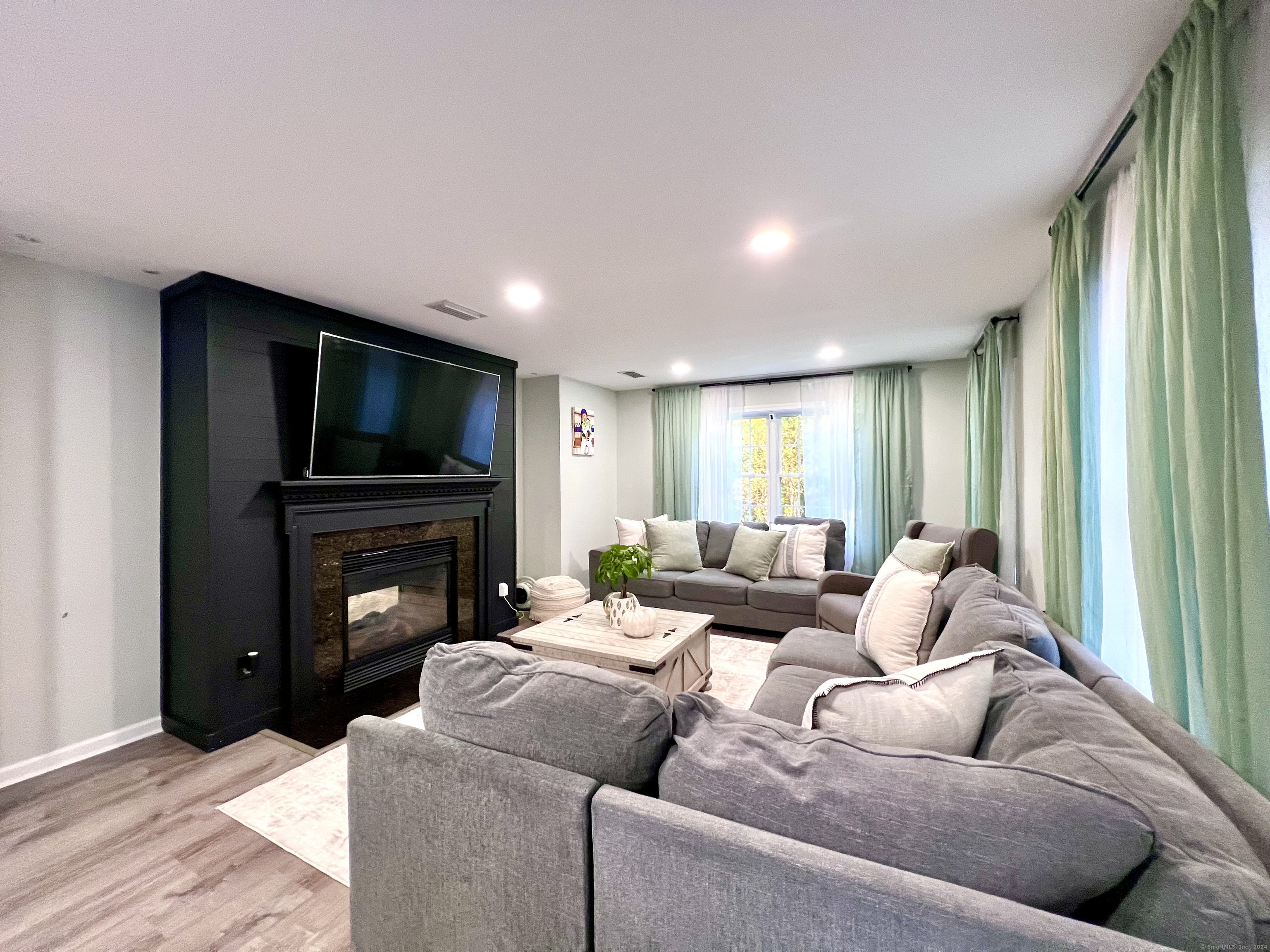 4 Cobblestone Court Naugatuck, CT 06770 - Photo 8 of 34 a living room with furniture and a fireplace