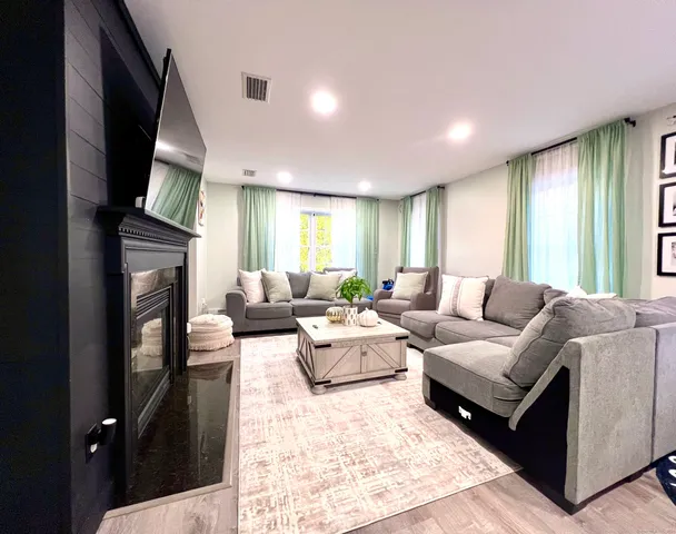 a living room with furniture fireplace and flat screen tv