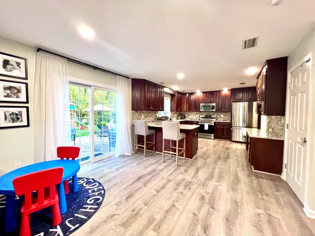 a living room with furniture and a kitchen