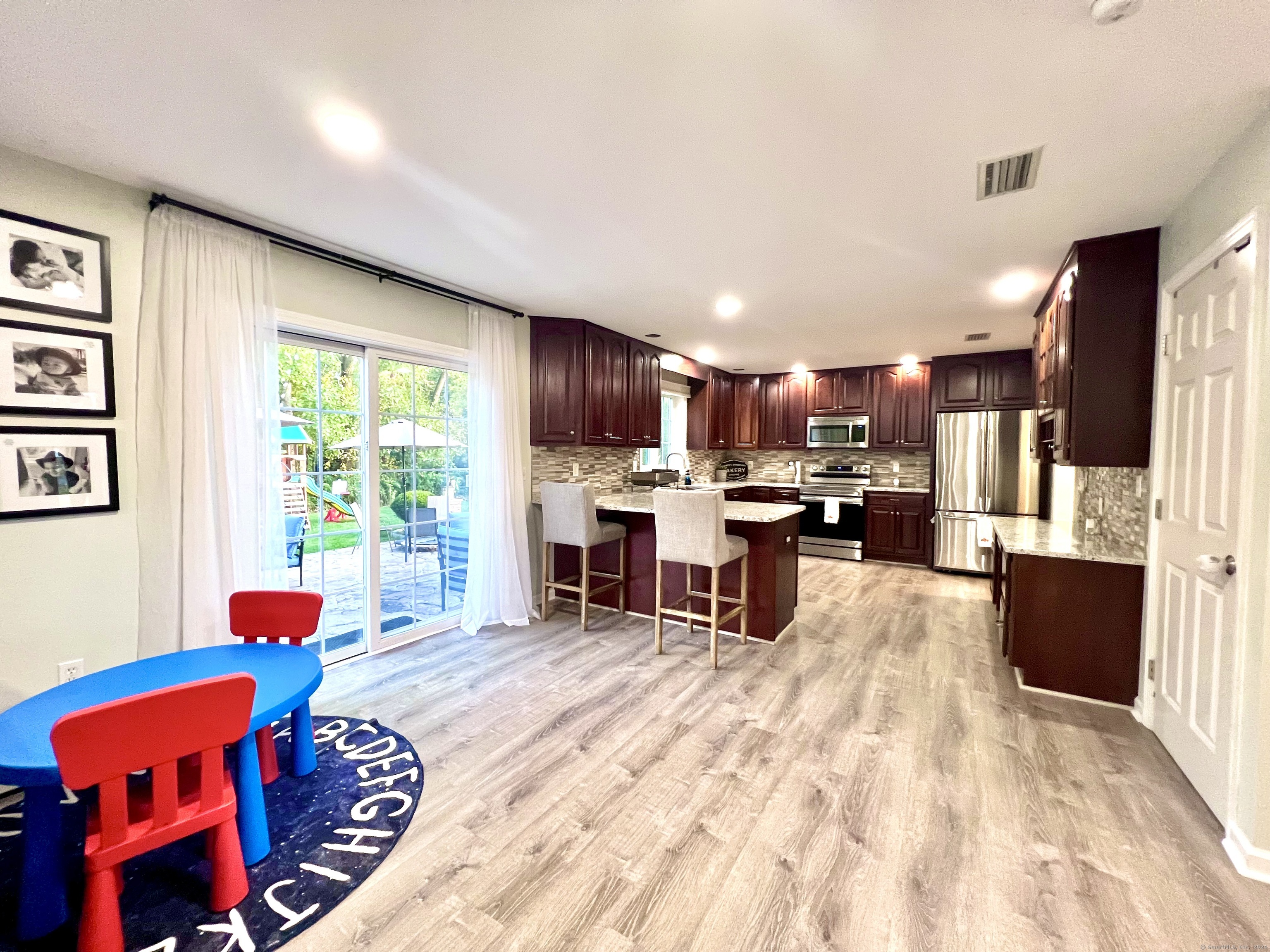 4 Cobblestone Court Naugatuck, CT 06770 - Photo 10 of 34 a living room with furniture and a kitchen