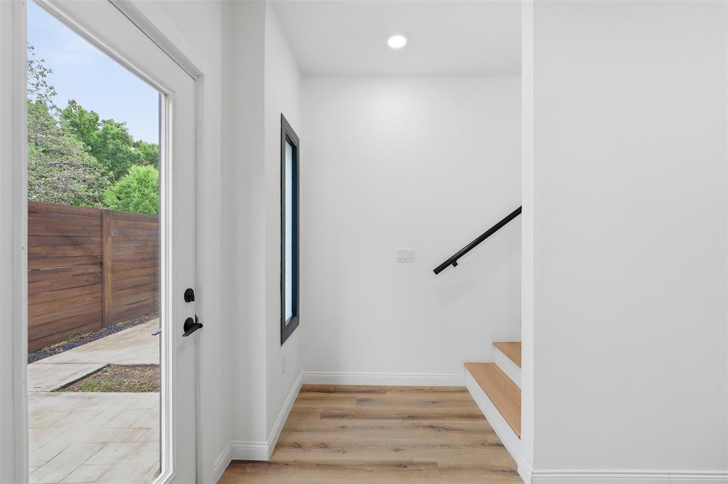 1920 Caddo Street, Unit 204 Dallas, TX 75204 - Photo 29 of 33 a view of a hallway with wooden floor and entryway