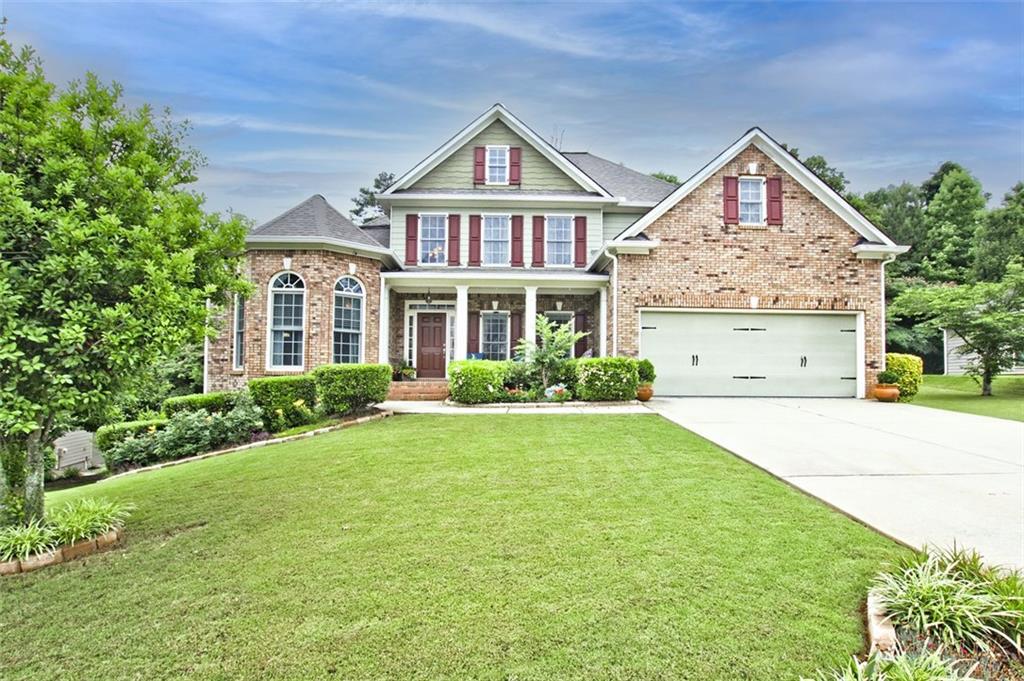 166 Thorn Creek Way Dallas, GA 30157 - Photo 1 of 1 a front view of a house with garden