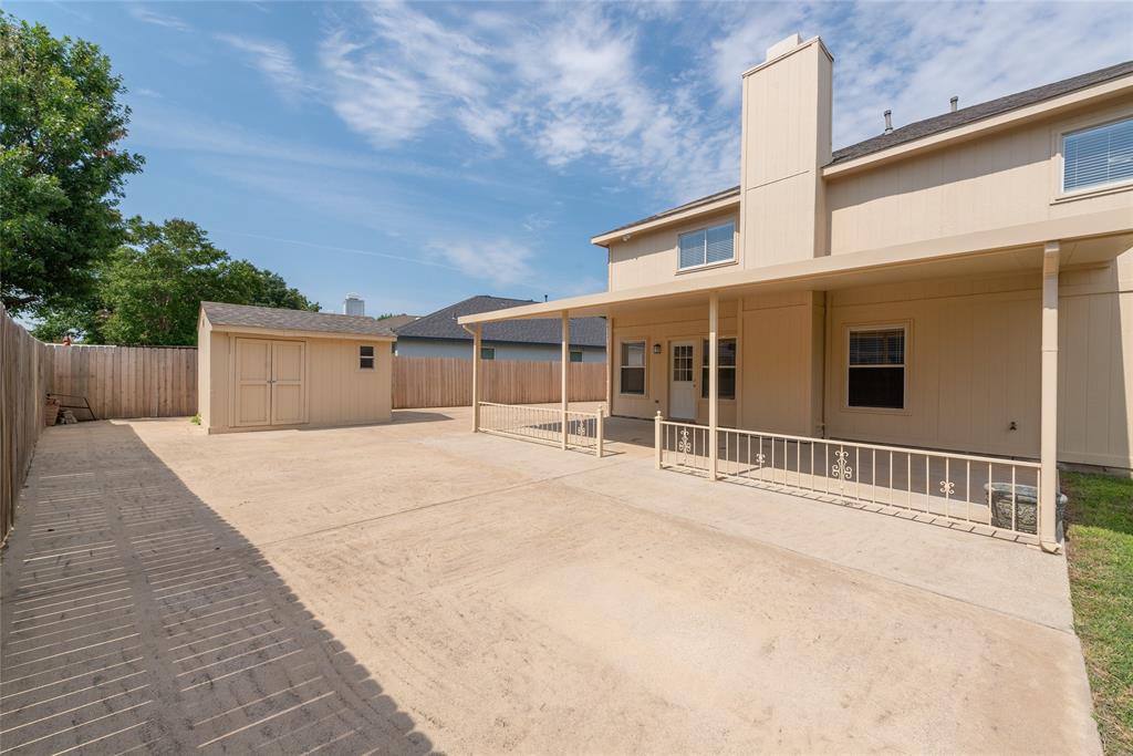 1157 Whistle Saginaw, TX 76131 - Photo 26 of 33 a house with a large window and wooden fence