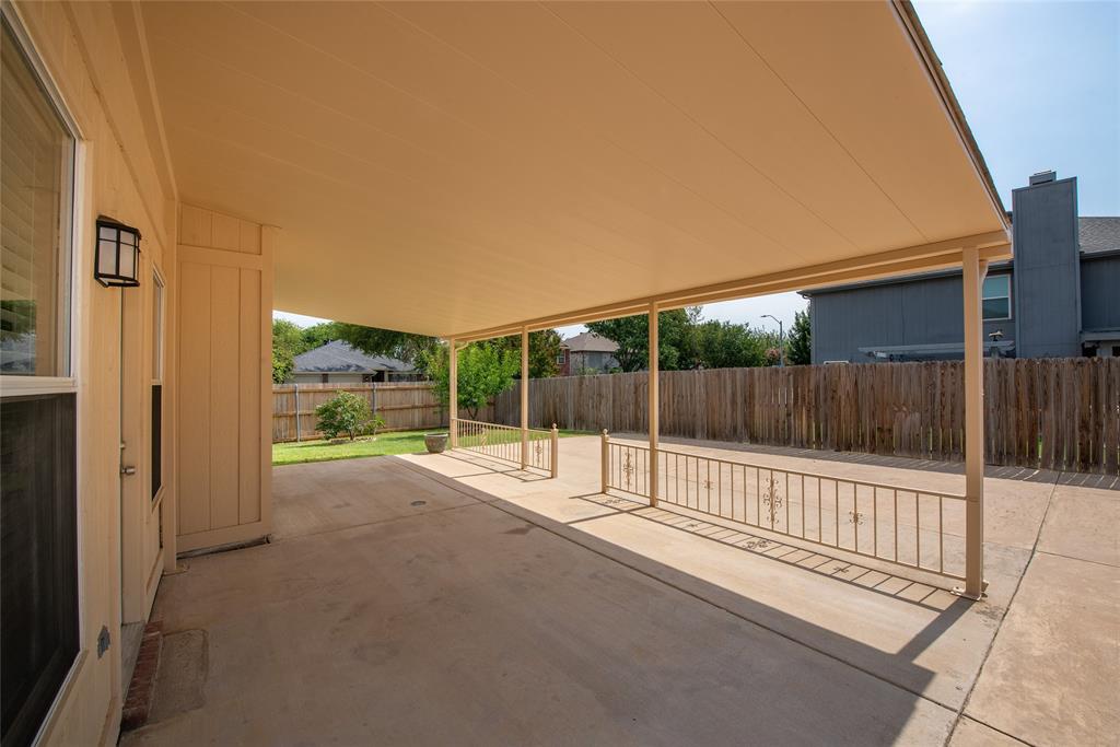 1157 Whistle Saginaw, TX 76131 - Photo 27 of 33 a view of a backyard and floor to ceiling window