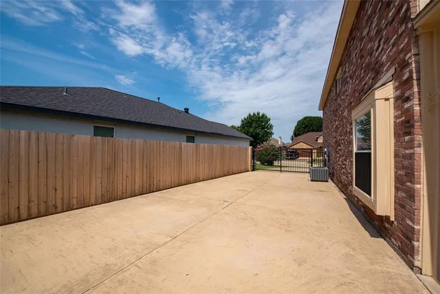 a view of backyard with patio