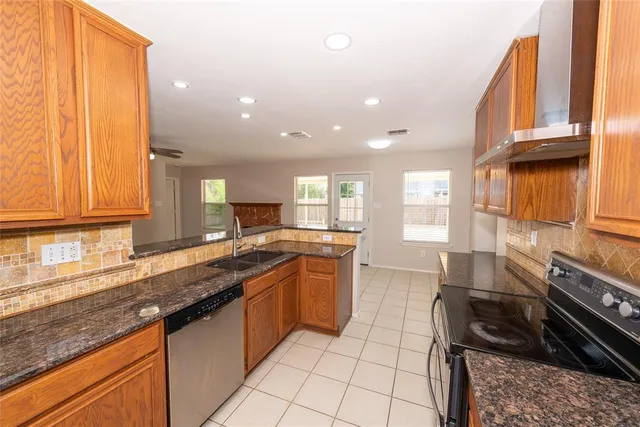 a kitchen with a sink stove and cabinets