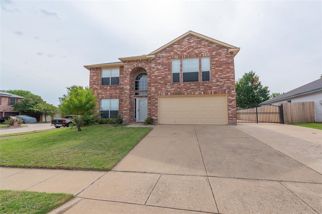 1157 Whistle Saginaw, TX 76131 - Photo 32 of 33 a front view of a house with a yard and garage