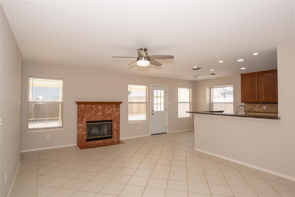 1157 Whistle Saginaw, TX 76131 - Photo 4 of 33 an empty room with windows and fireplace