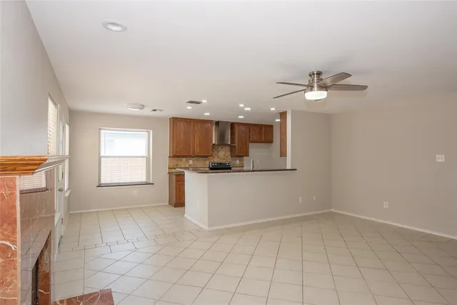 a view of kitchen with granite countertop white cabinets and white appliances