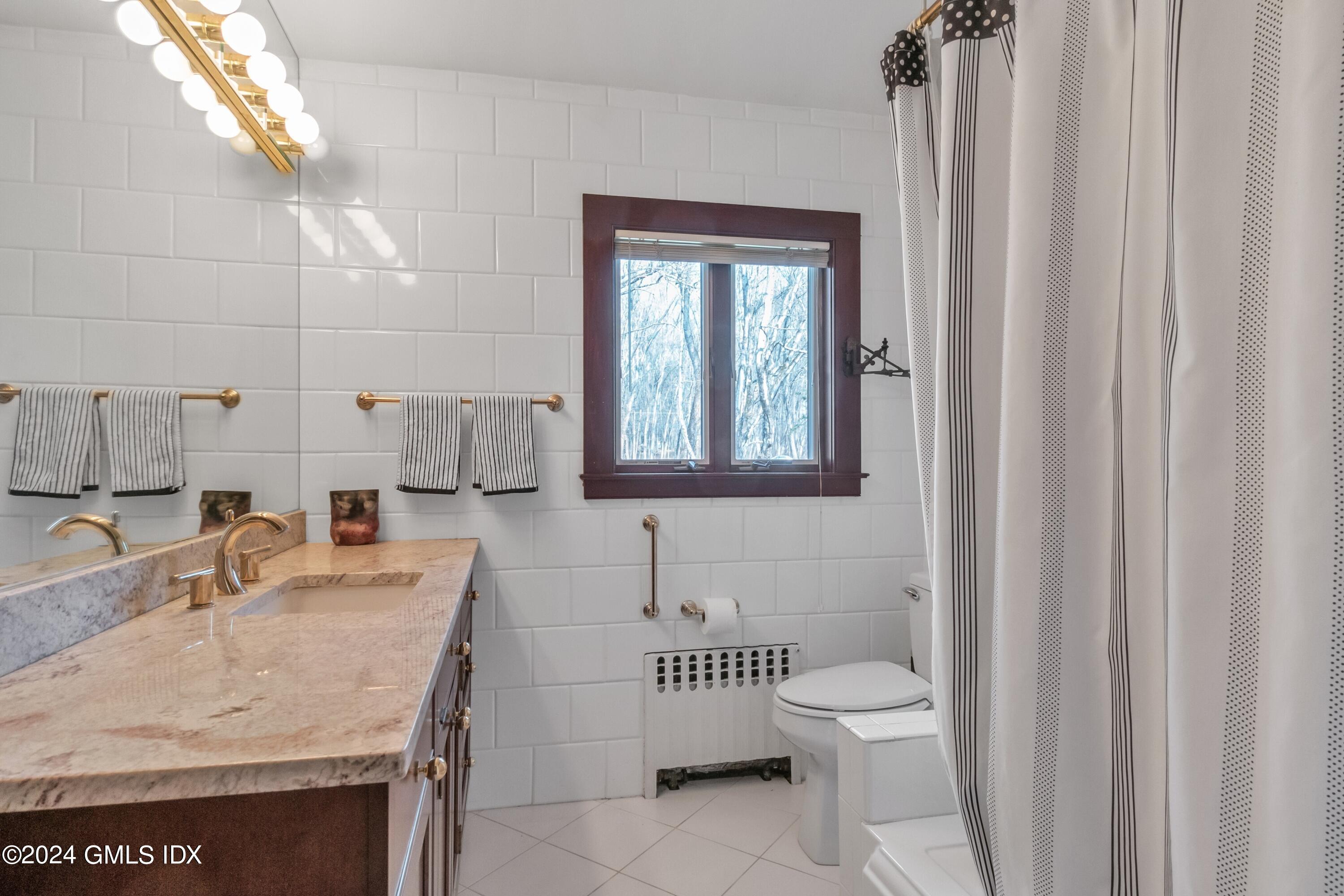 129 Cutler Road Greenwich, CT 06831 - Photo 14 of 17 a bathroom with a sink toilet and mirror