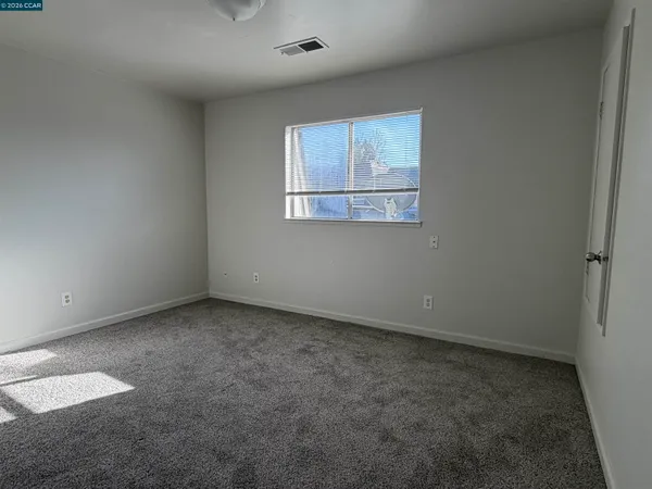 an empty room with a empty space and window