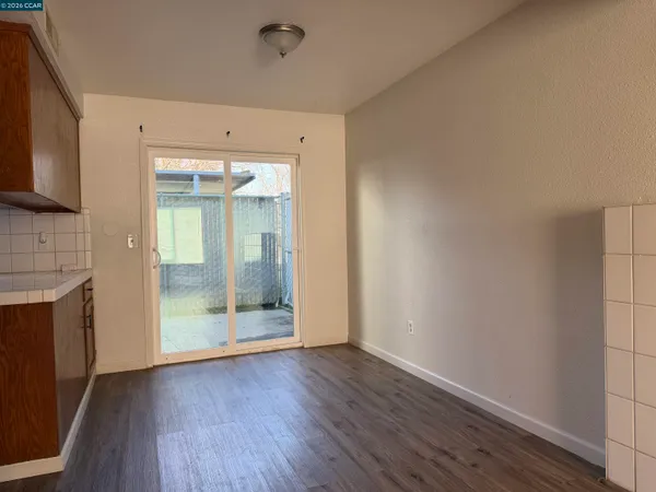 a view of a kitchen with wooden floor and a fireplace
