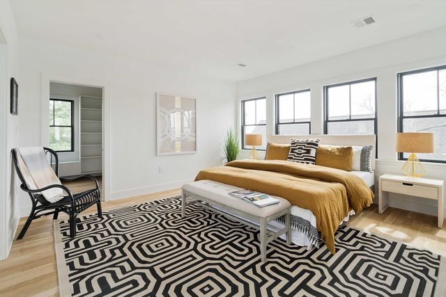 a spacious bedroom with a bed and a window