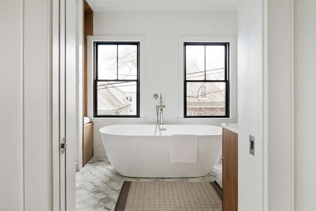a white bath tub sitting next to a window
