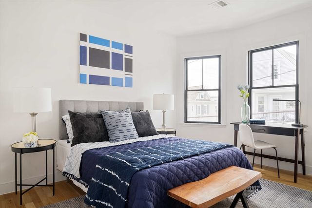 a bedroom with a bed and a table