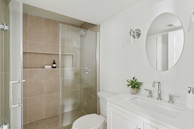 a bathroom with a sink toilet and shower