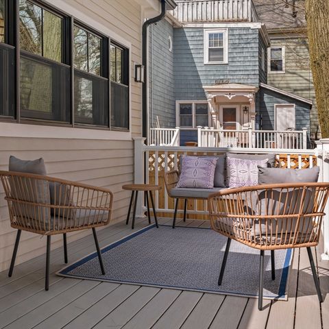 a roof deck with table and chairs