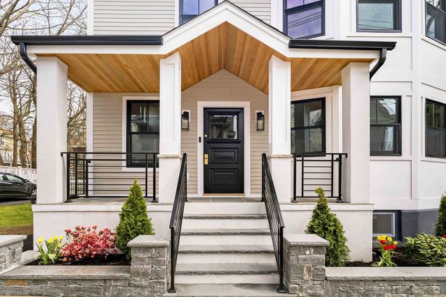 a front view of a house with a garden