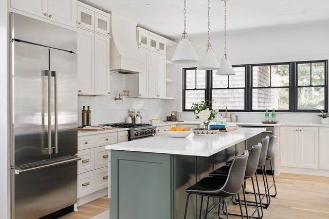 a kitchen with a sink stainless steel appliances and window