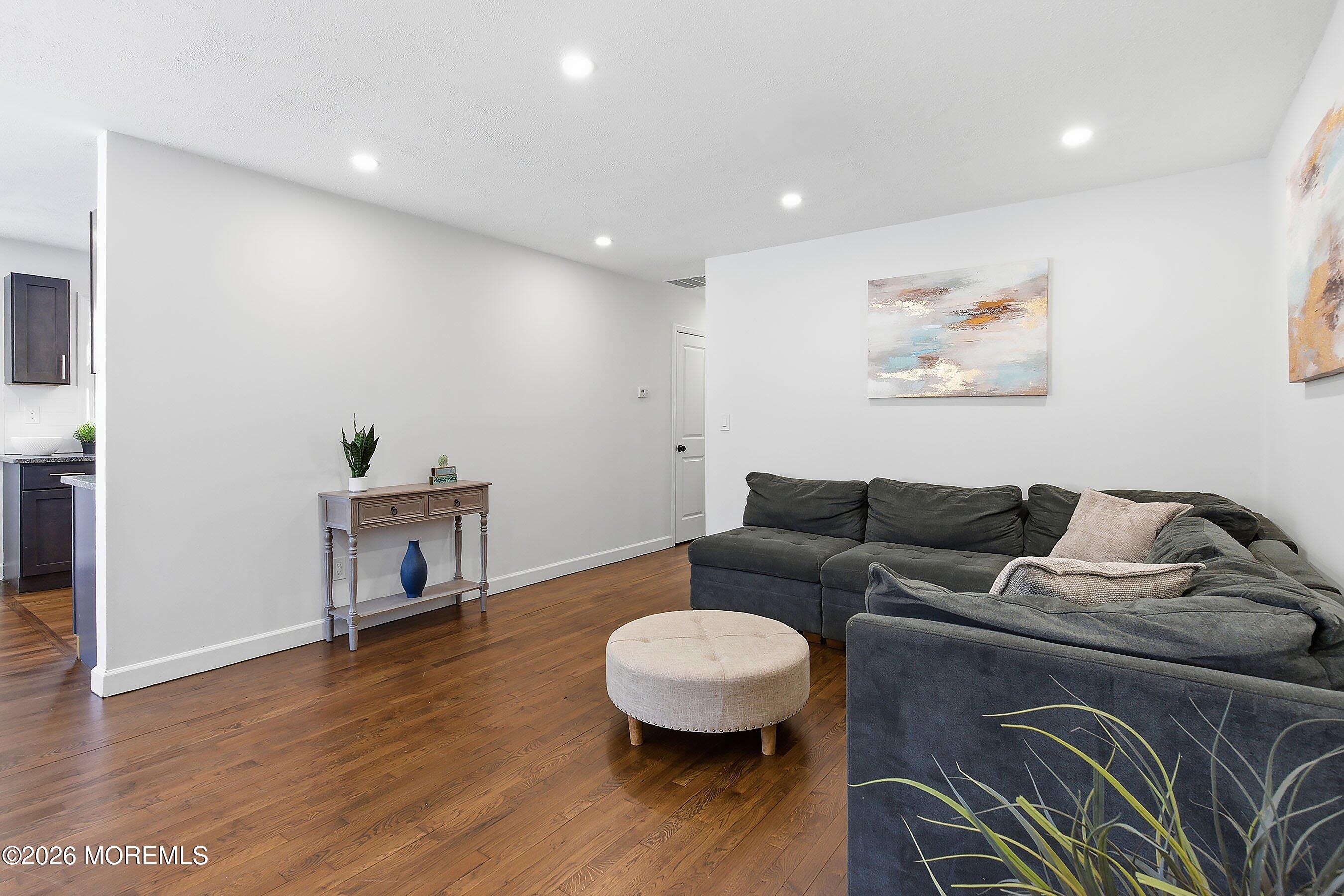 123 West 4th Street Howell, NJ 07731 - Photo 16 of 25 a living room with furniture and a wooden floor