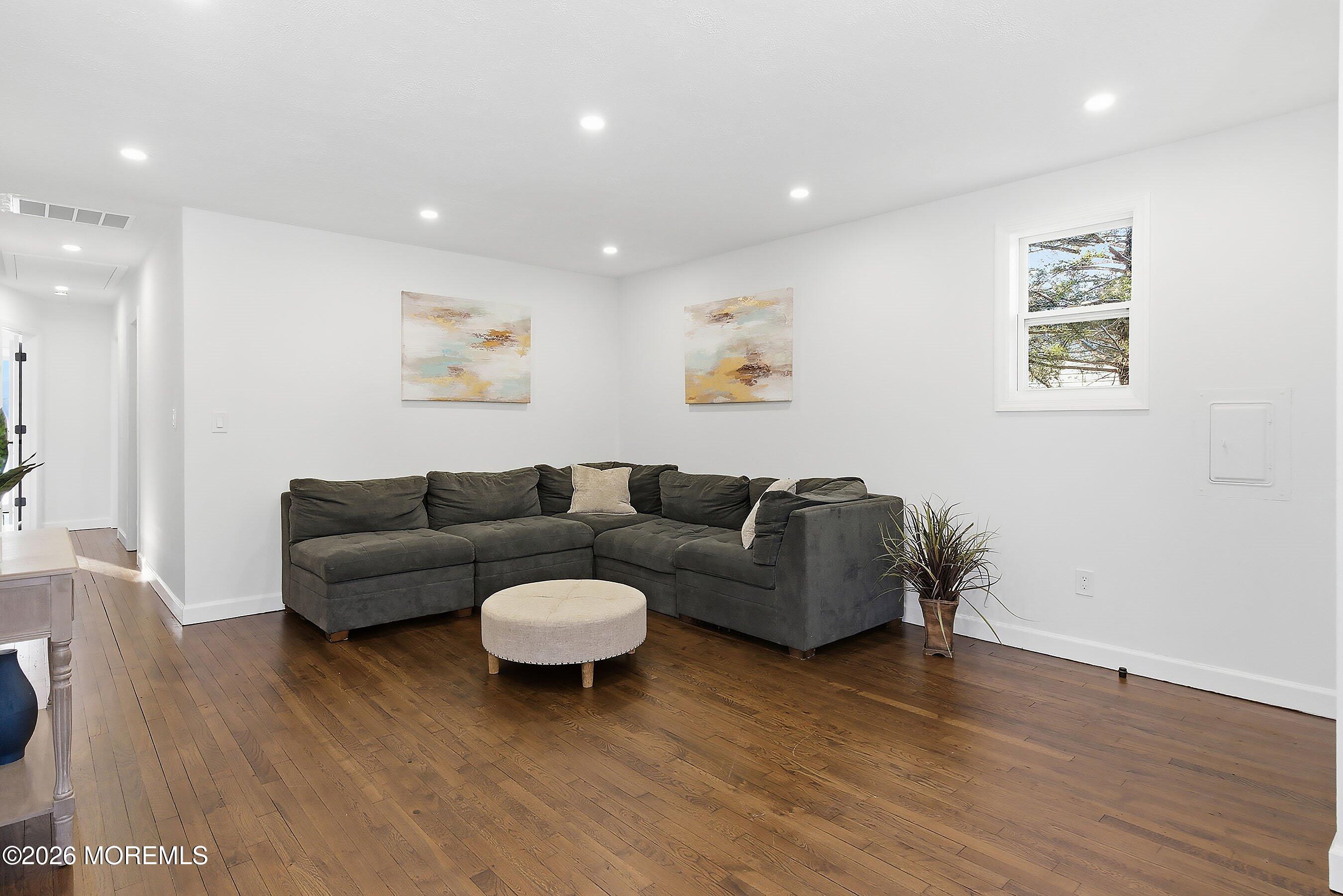 123 West 4th Street Howell, NJ 07731 - Photo 17 of 25 a living room with furniture and a wooden floor