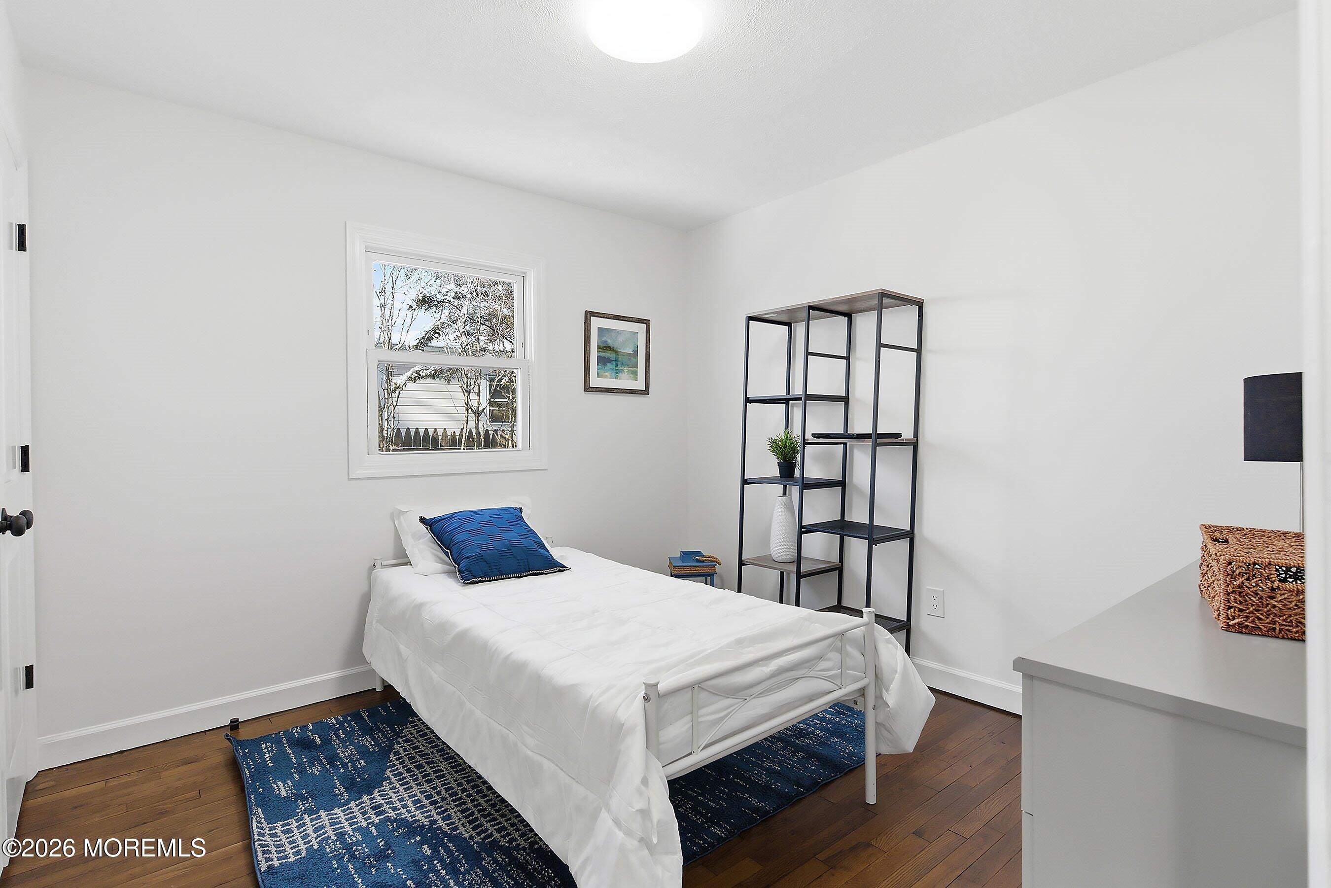 123 West 4th Street Howell, NJ 07731 - Photo 20 of 25 a bedroom with a bed and a bookshelf
