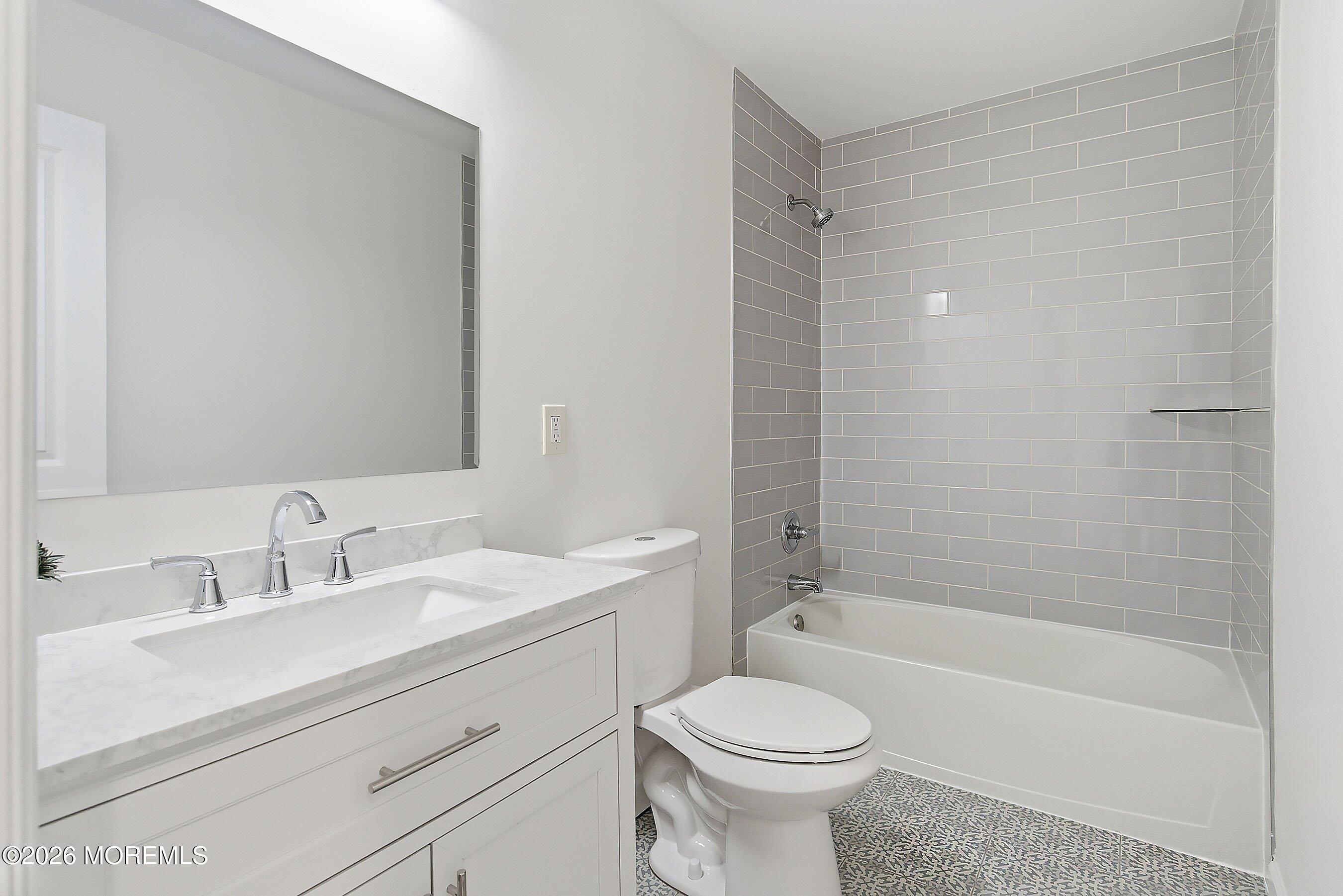 123 West 4th Street Howell, NJ 07731 - Photo 21 of 25 a bathroom with a sink a toilet and a bathtub
